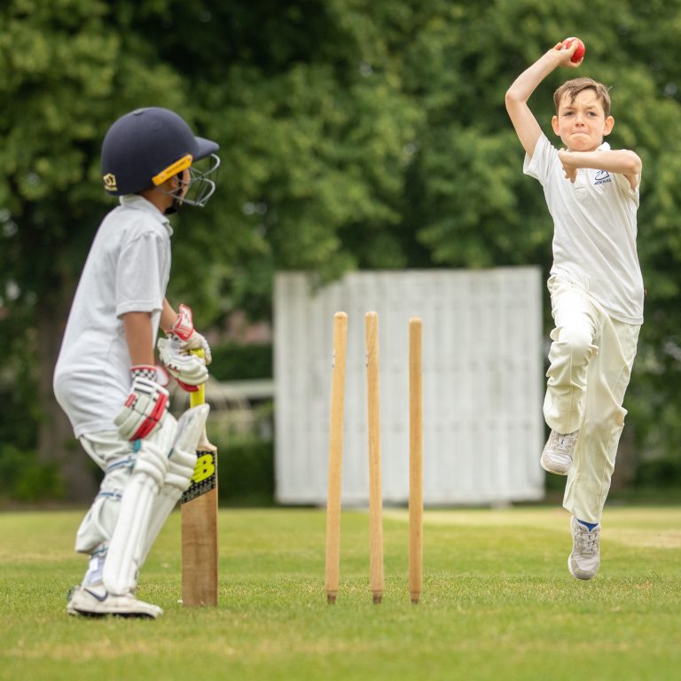 children playing cricket together