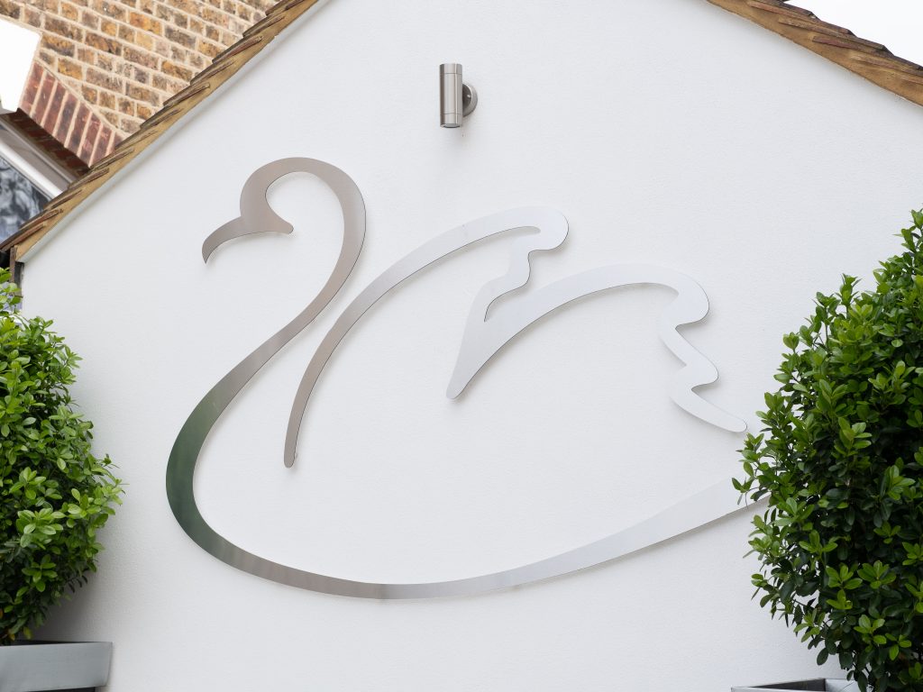 Avon House Swan Logo on the side of an external wall