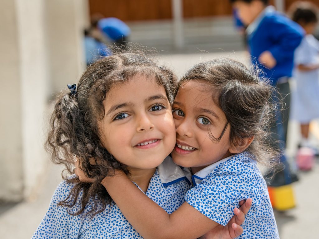 2 students hugging