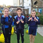 Students showing off their Swimming Medals