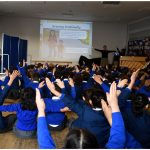 Students waving their hands in the air