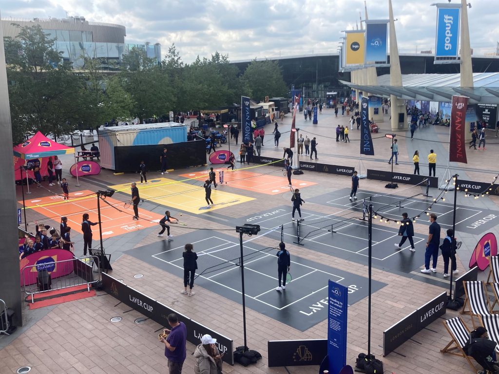 Young adults at the differently laid out tennis courts