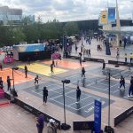 Young adults at the differently laid out tennis courts