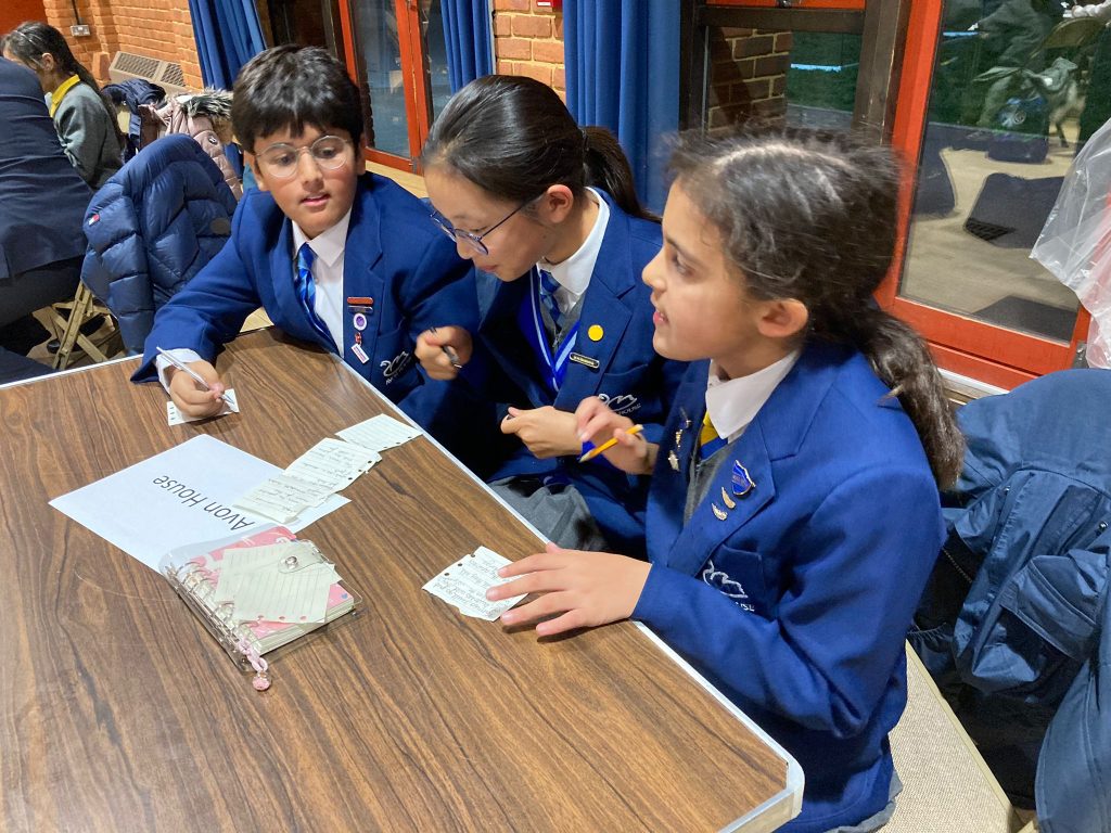 children sat outside doing their work