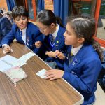 children sat outside doing their work