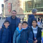 children in front of a football stadium