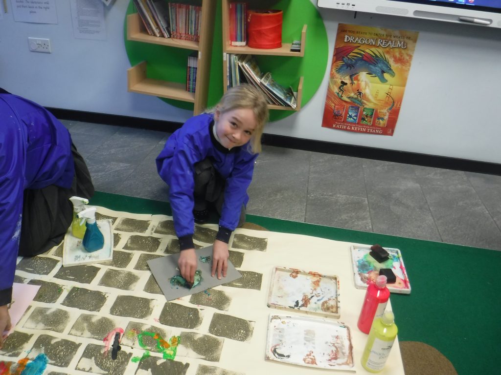 girl painting on the floor