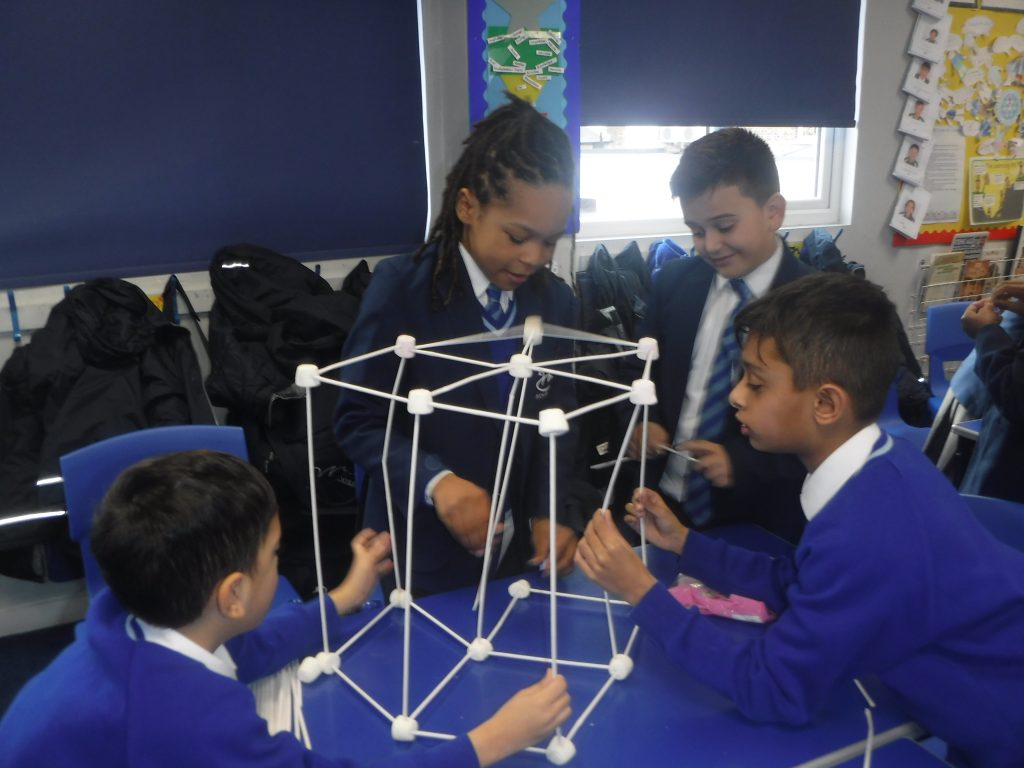 children building using straws and marshmallows