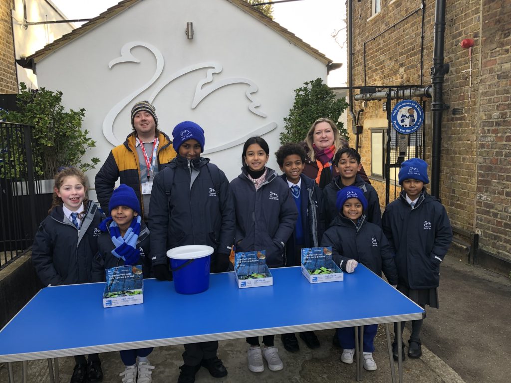 students standing by a charity table