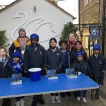 students standing by a charity table