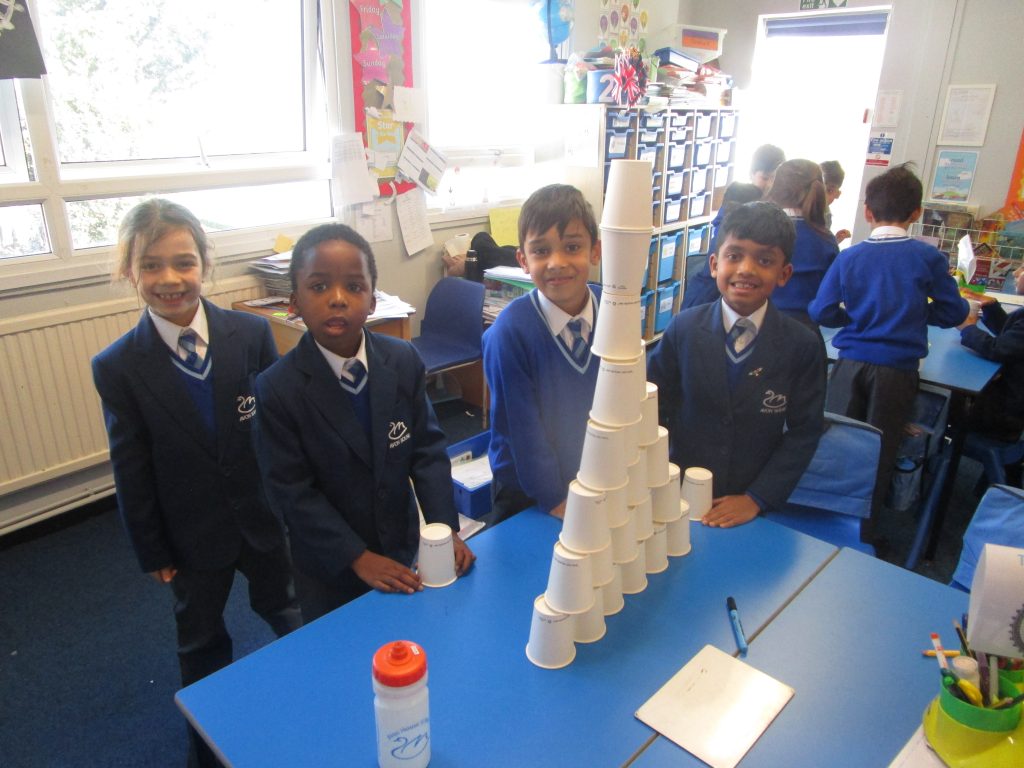 students stacking cups