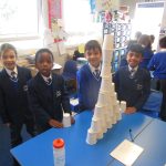 students stacking cups