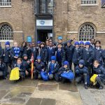 Students in a big group stood outside the Museum of Docklands in London