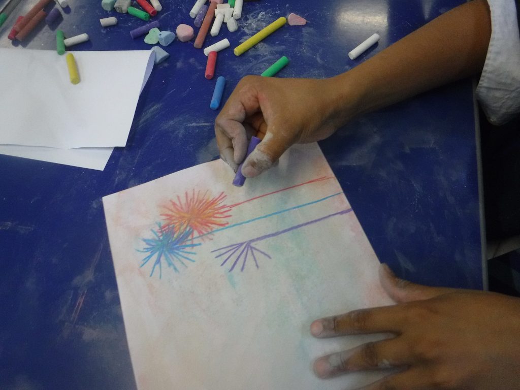 student using coloured chalk