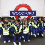 Students sat on a bench at Woodfood station