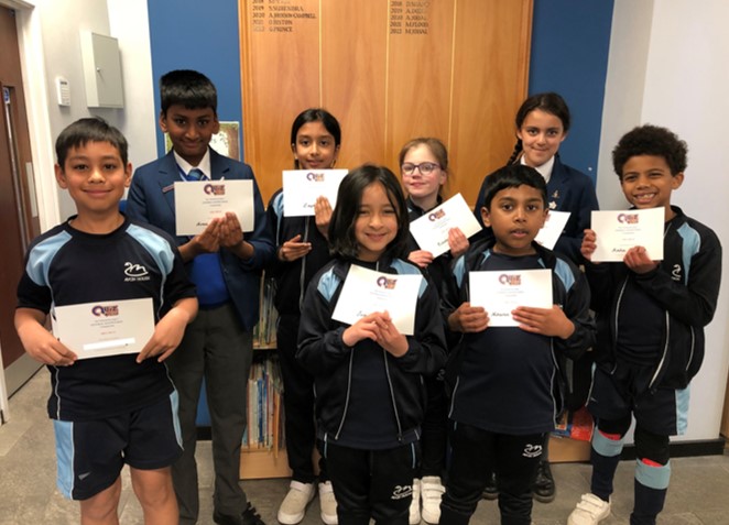 students holding their certificates