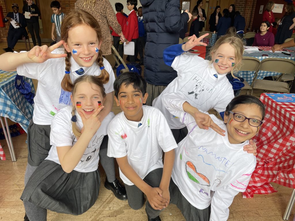 students dressed with big t-shirts on from different countries