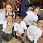 students dressed with big t-shirts on from different countries