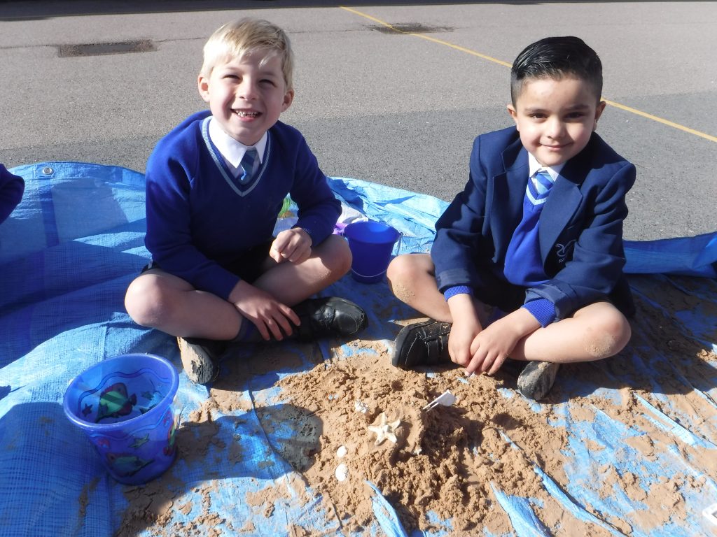 pupils sat in sand