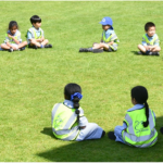 pupils sat on a field