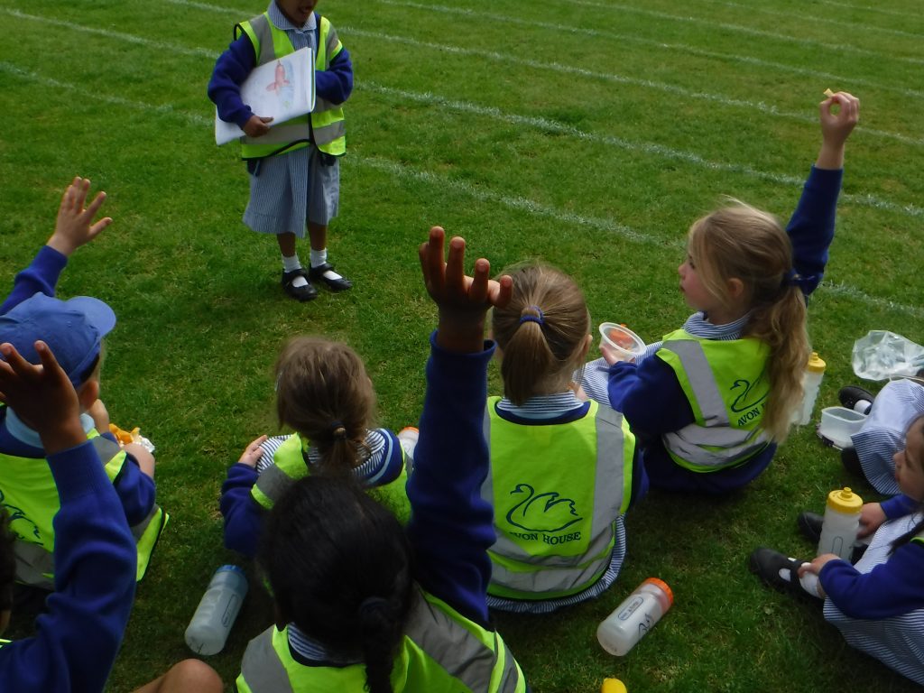 Young pupils sat in a field