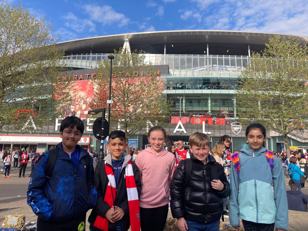 Students standing outside a football stadium