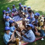 Children sat on a picnic blanket