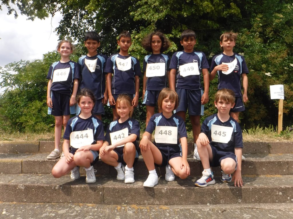 Students wearing race numbers on the fronts of their t-shirts
