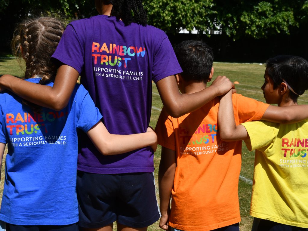 Children with arms around each other for the Rainbow Trust