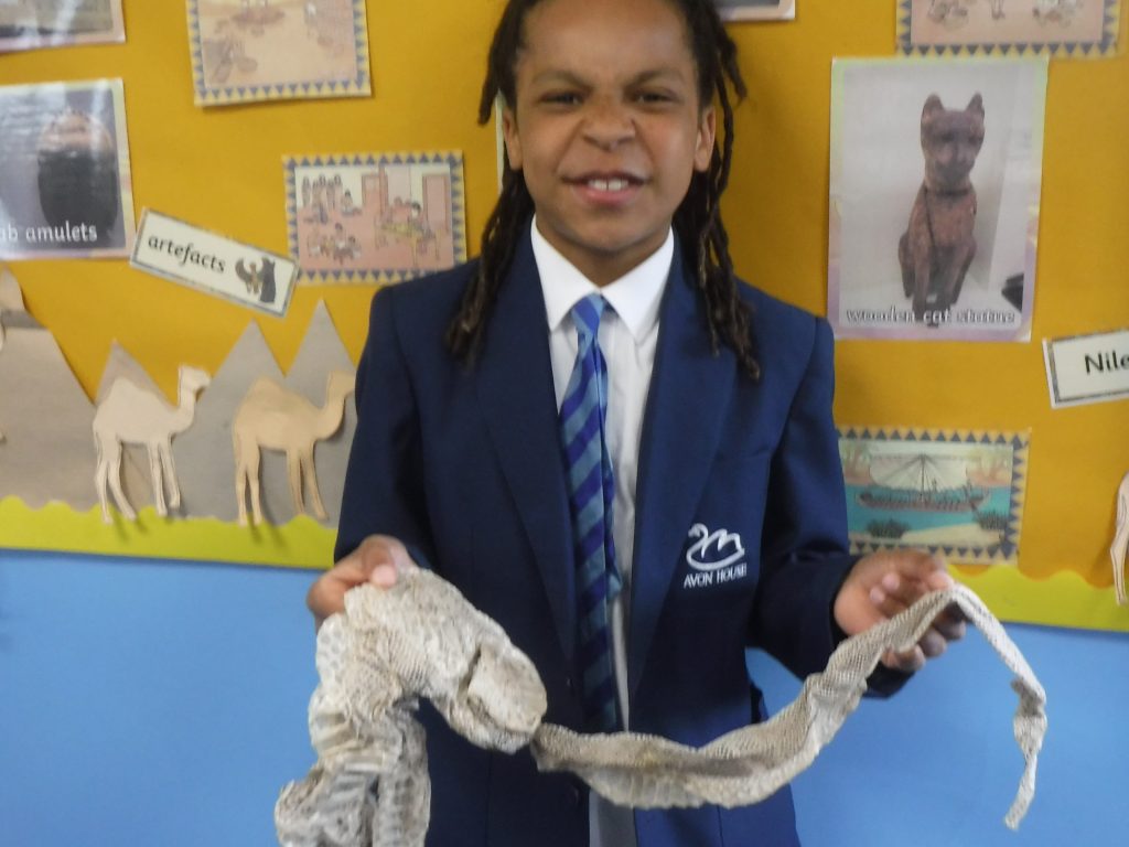 Student holding a long piece of fabric