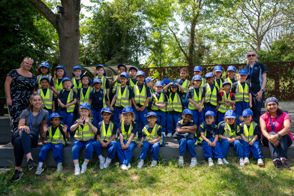 Students in hi-viz and hard hats