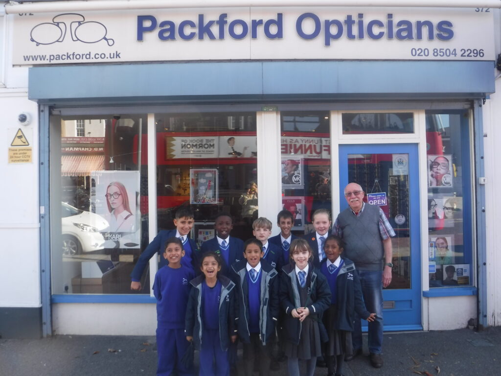 students in front of an opticians