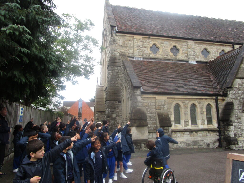 students pointing at a building