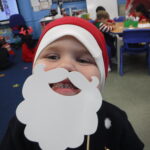 boy wearing a santa beard