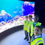 students by the aquarium