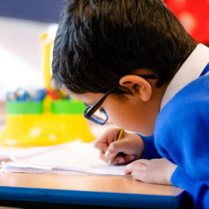 boy writing in class