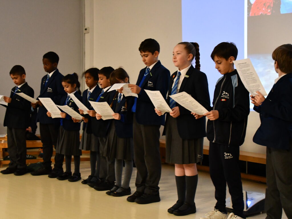 students holding sheets of paper