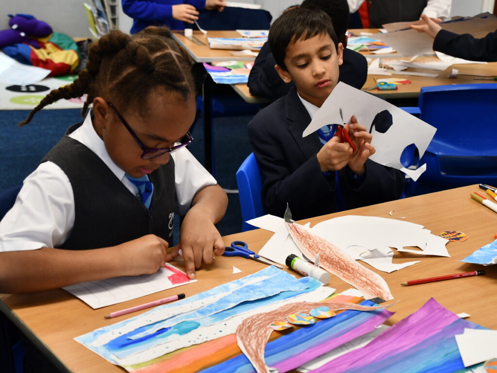 students cutting and sticking