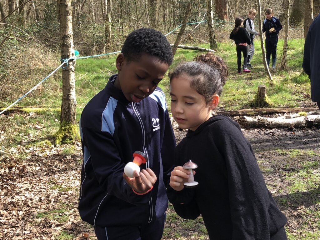 two school children in the woods