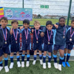 a school football team wearing medals and sport kits