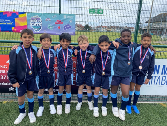 a school football team wearing medals and sport kits