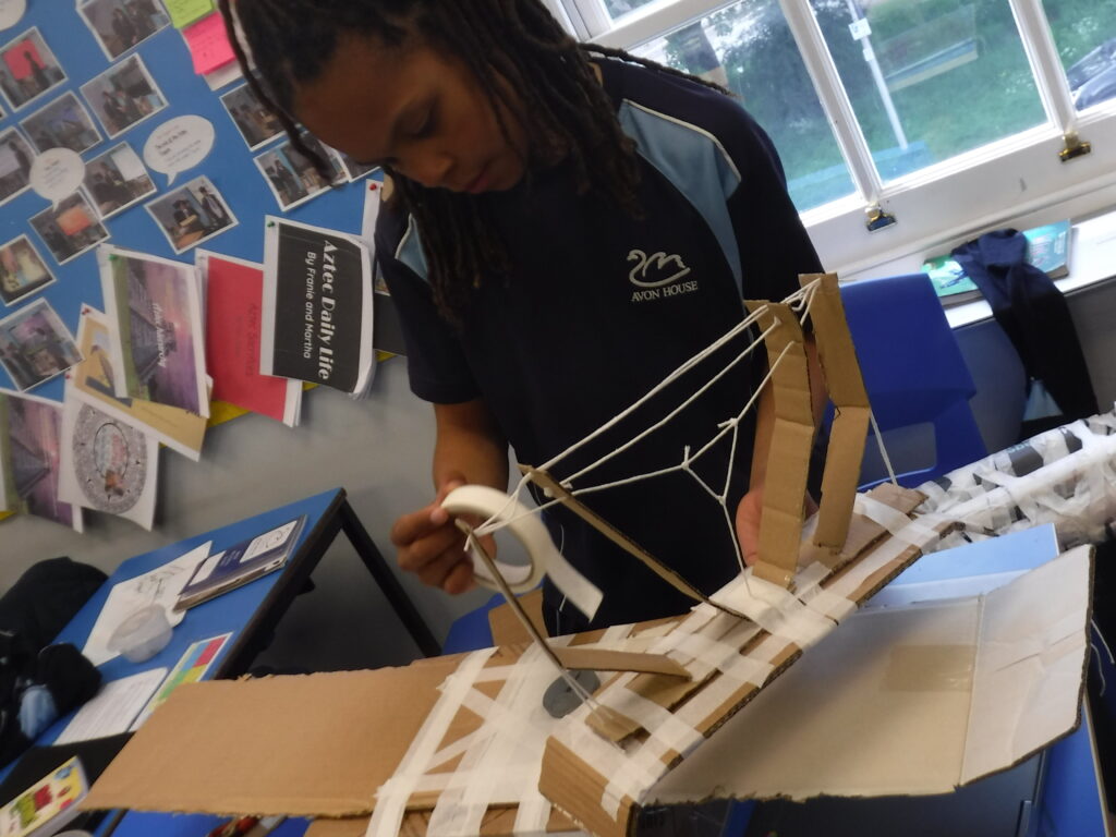 school student creating a model bridge