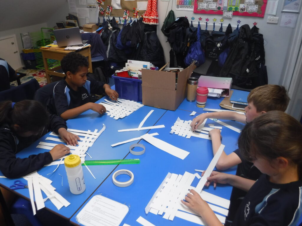 students cutting and sticking