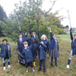 students holding litter pickers