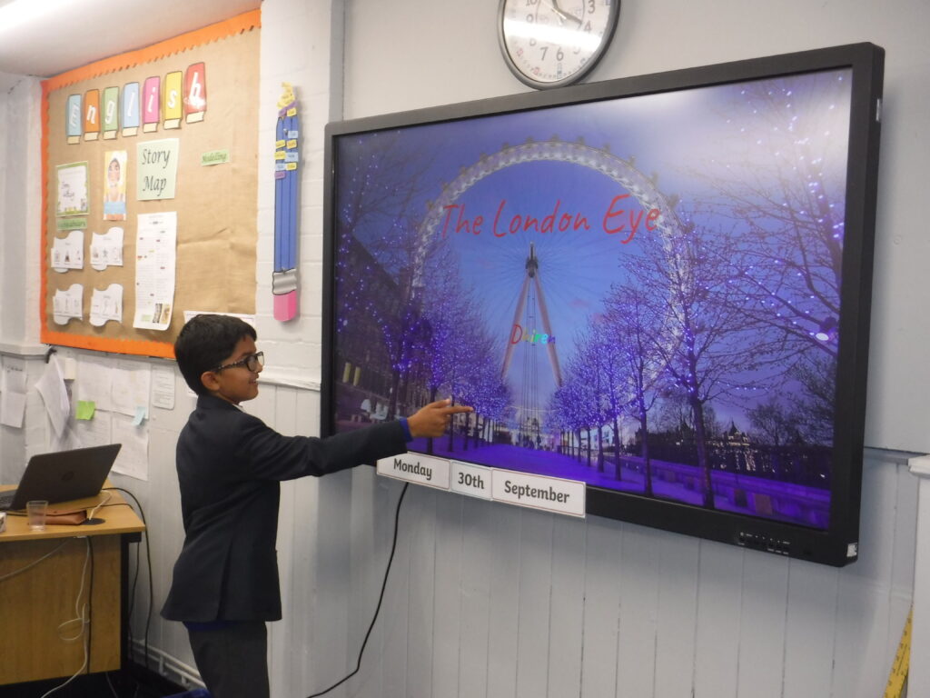 student pointing at a screen