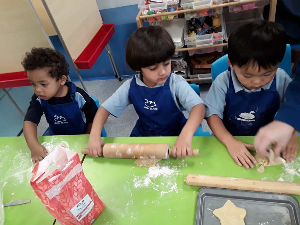 students rolling out dough
