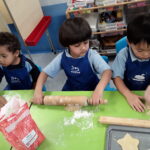 students rolling out dough